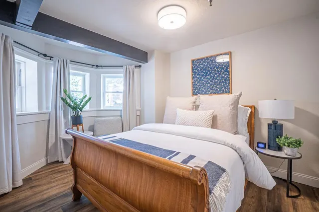 a living room with furniture kitchen view and a chandelier