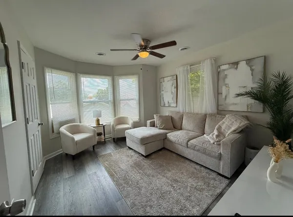 a living room with furniture and a large window