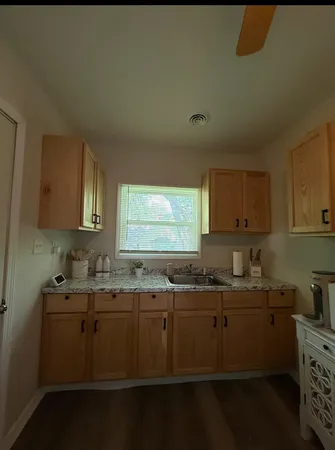 a kitchen with sink stove and cabinets