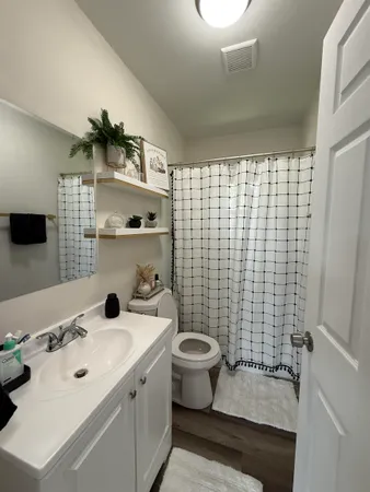 a bathroom with a sink toilet and shower
