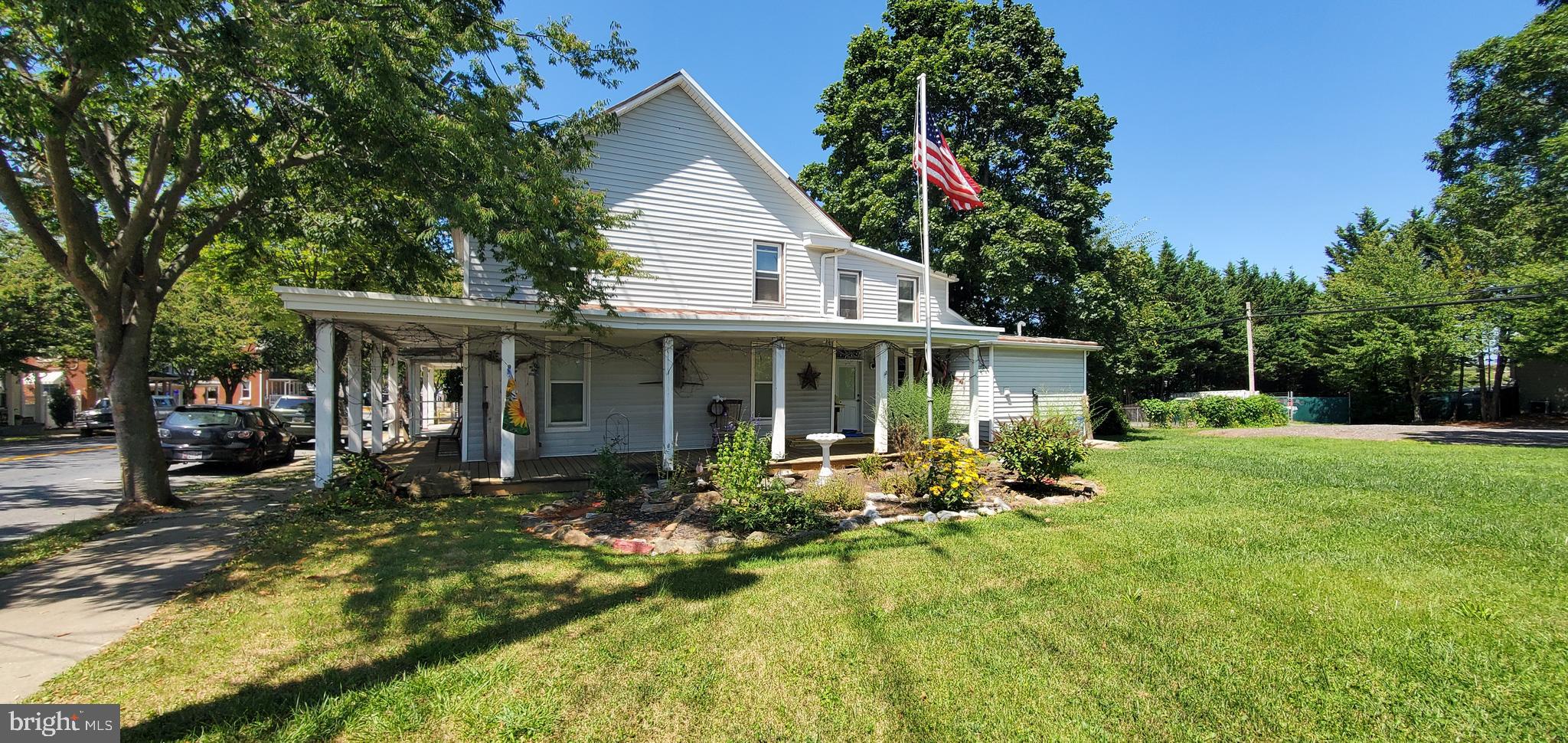a front view of a house with garden and porch