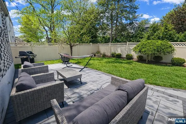 a view of backyard with seating area and green space