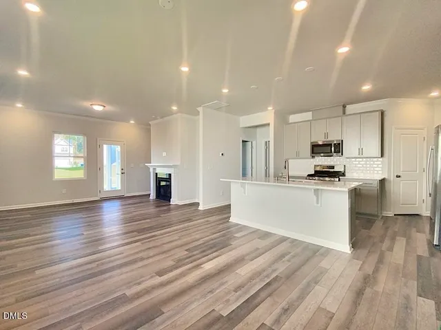 a view of kitchen with cabinets and wooden floor
