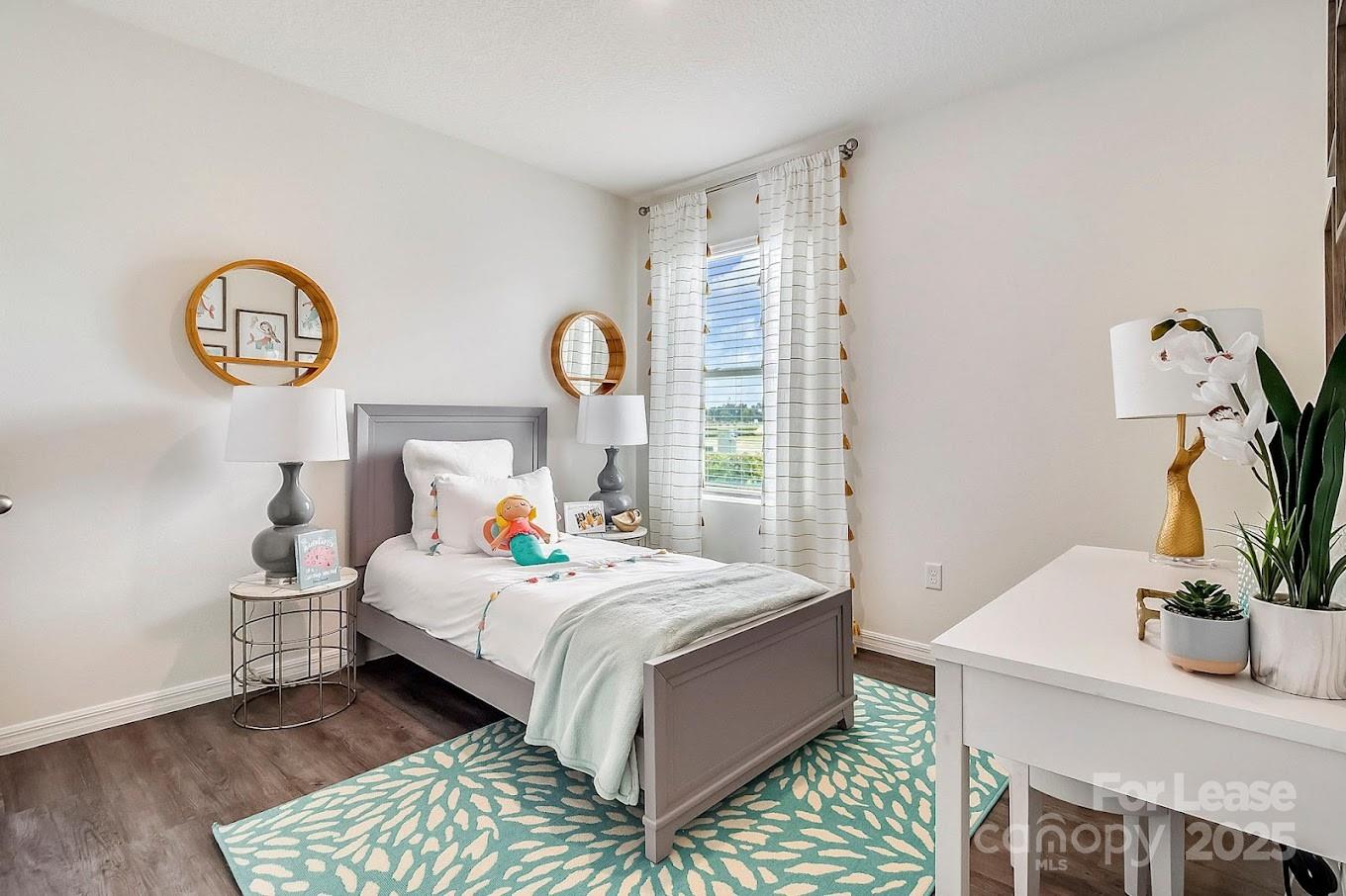 111 Switchgrass Loop, Unit ARIA Fairview, NC 28730 - Photo 15 of 20 a bedroom with a bed and a table