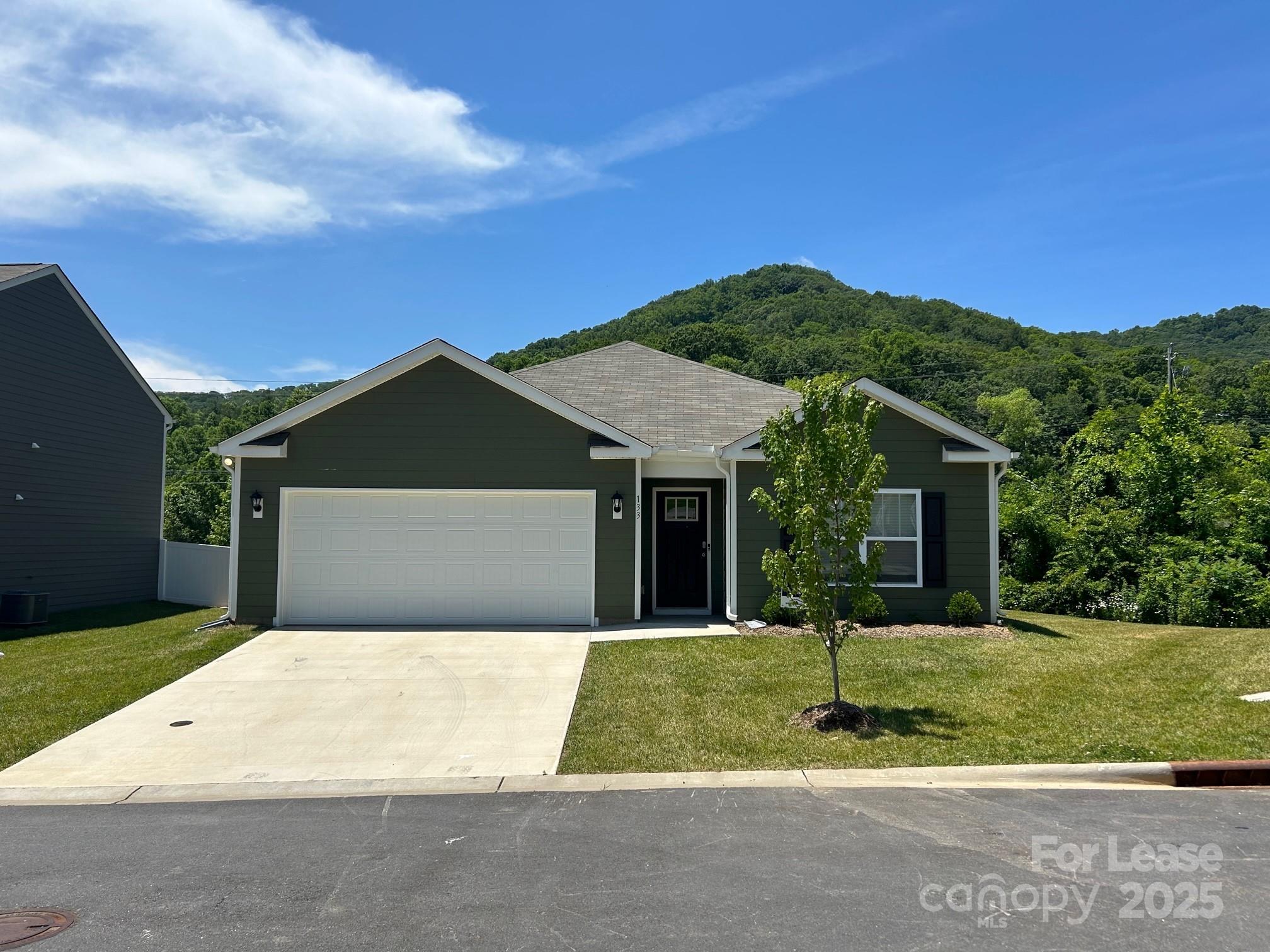 111 Switchgrass Loop, Unit ARIA Fairview, NC 28730 - Photo 2 of 20 a front view of a house with a yard and garage