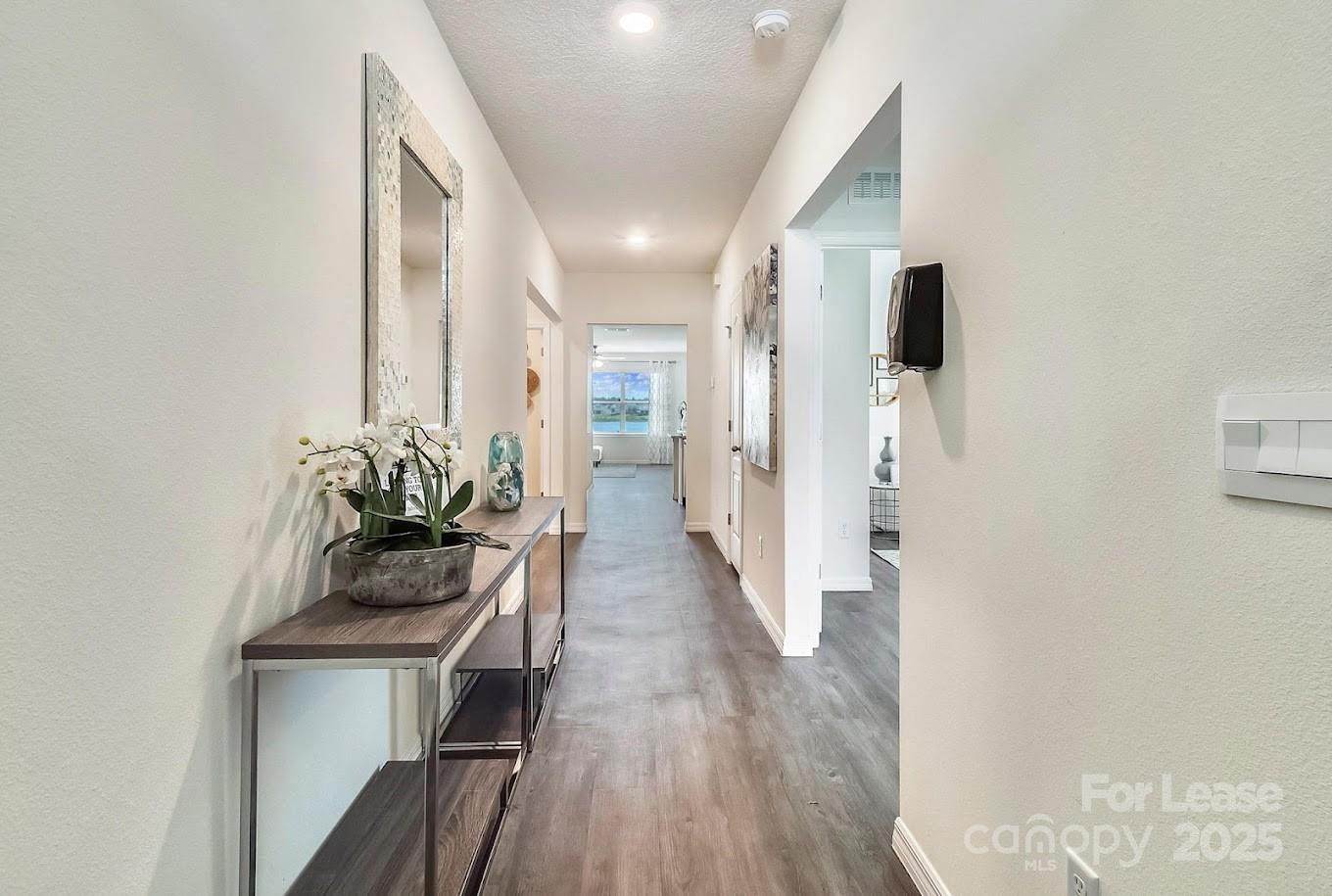 111 Switchgrass Loop, Unit ARIA Fairview, NC 28730 - Photo 3 of 20 a living room with furniture and a wooden floor