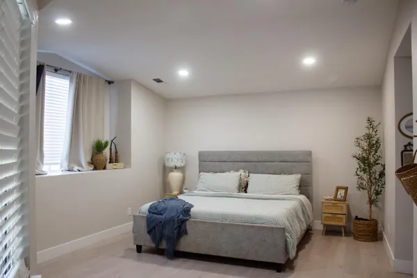 a bedroom with a bed and a window
