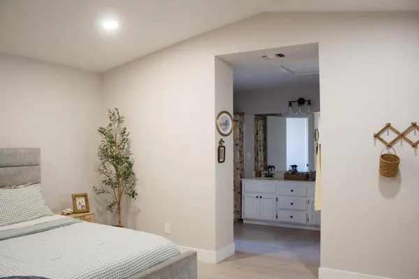 a bedroom with a bed and a mirror