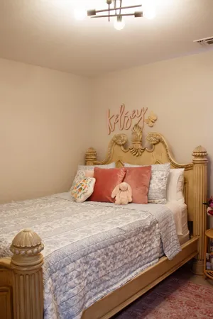 a bedroom with a bed and a mirror