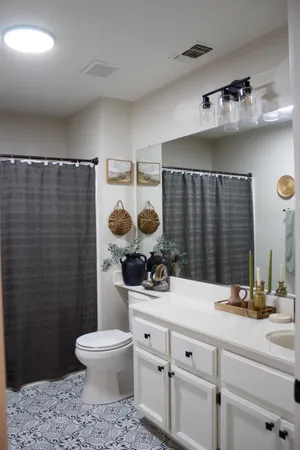 a bathroom with a sink a toilet and a mirror