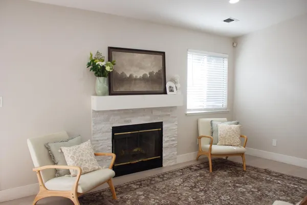 a living room with furniture and a fireplace