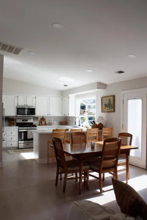 a view of a dining room with furniture and window