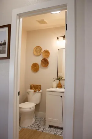 a bathroom with a toilet sink and mirror