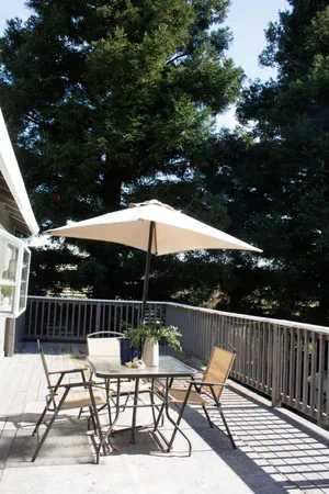 a patio with glass top table and chairs