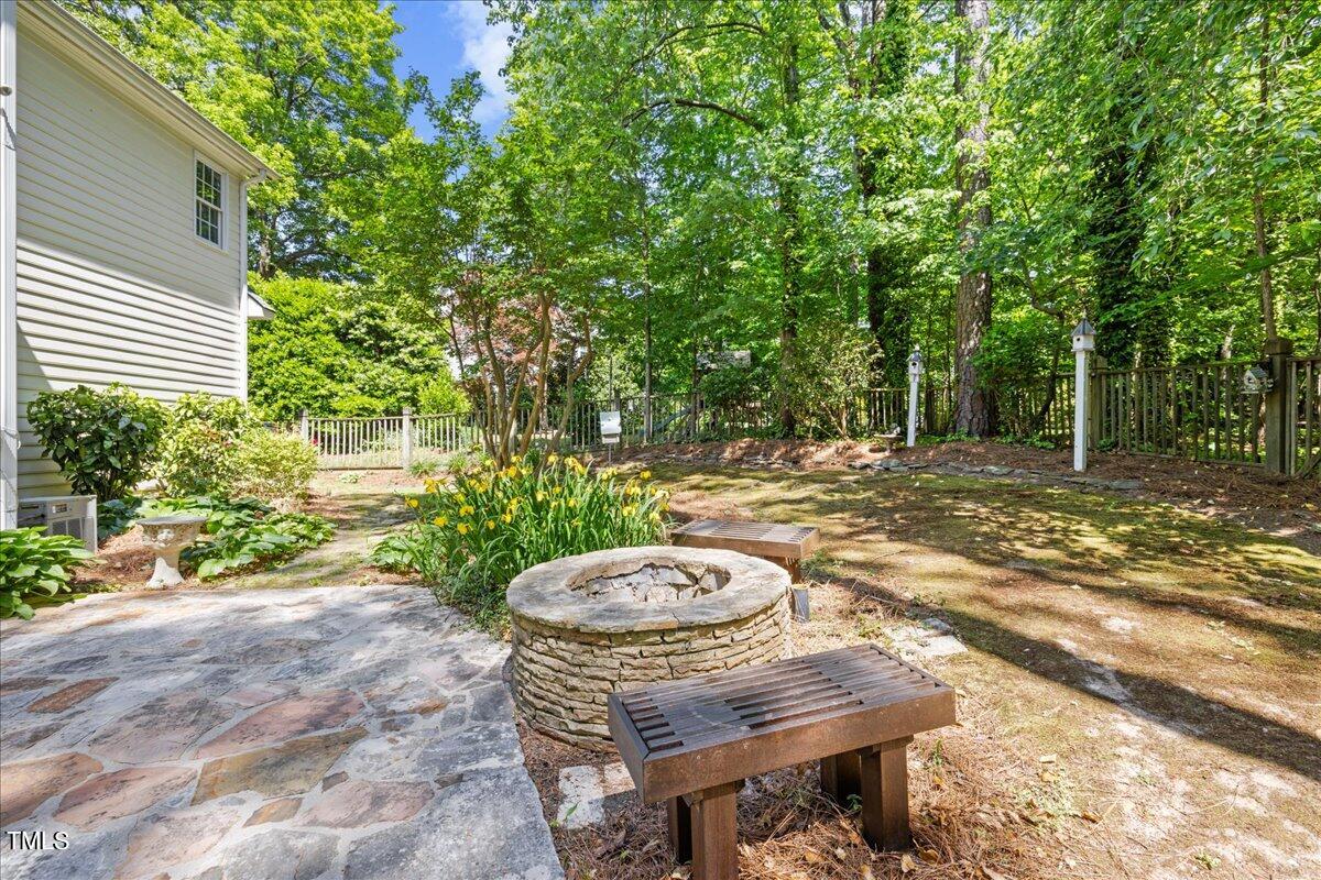 8604 Stanton Place Raleigh, NC 27615 - Photo 40 of 54 a backyard of a house with table and chairs
