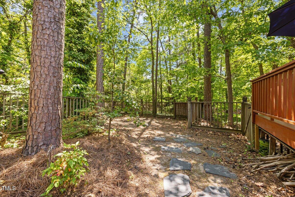 8604 Stanton Place Raleigh, NC 27615 - Photo 45 of 54 a backyard of a house with lots of green space and garden view