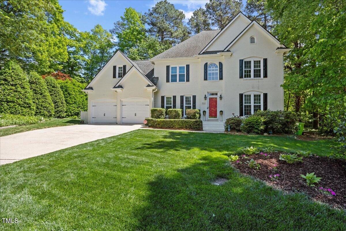 8604 Stanton Place Raleigh, NC 27615 - Photo 6 of 54 a front view of a house with a yard and trees