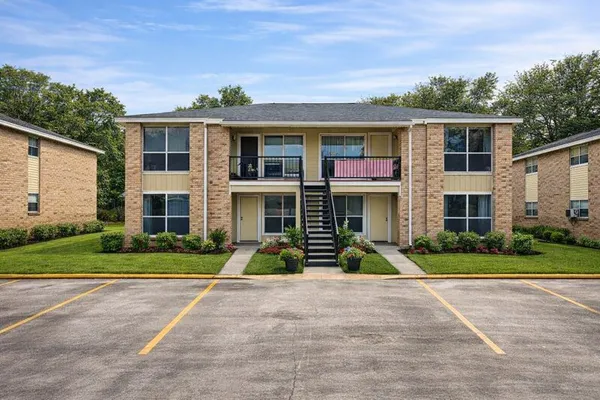 a large kitchen with stainless steel appliances granite countertop a stove oven and a refrigerator