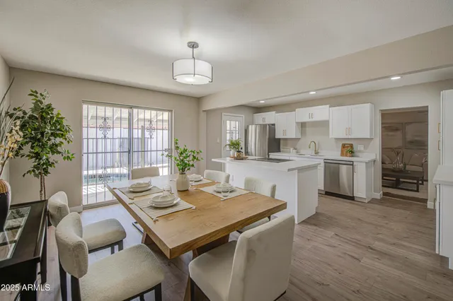 a view of a dining room with furniture and wooden floor