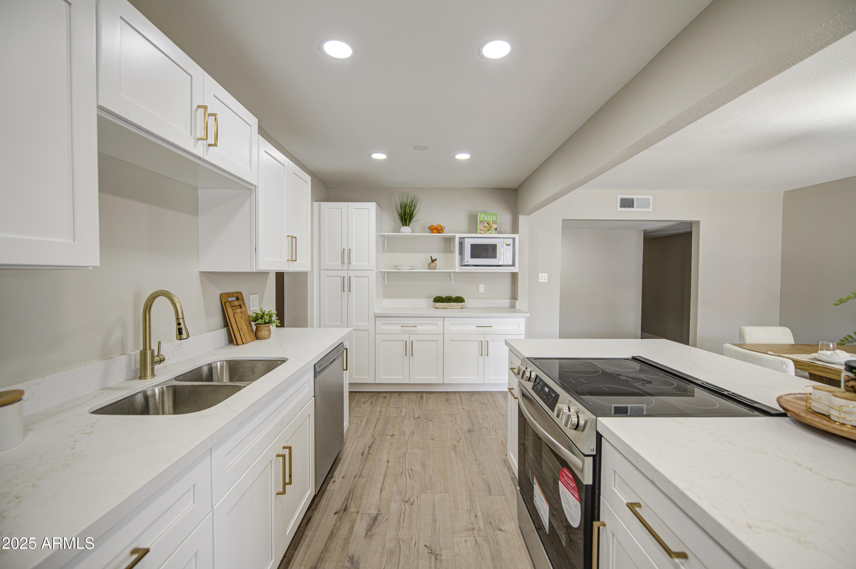 4750 North 39th Drive Phoenix, AZ 85019 - Photo 11 of 39 a kitchen with a sink stove top oven and cabinets