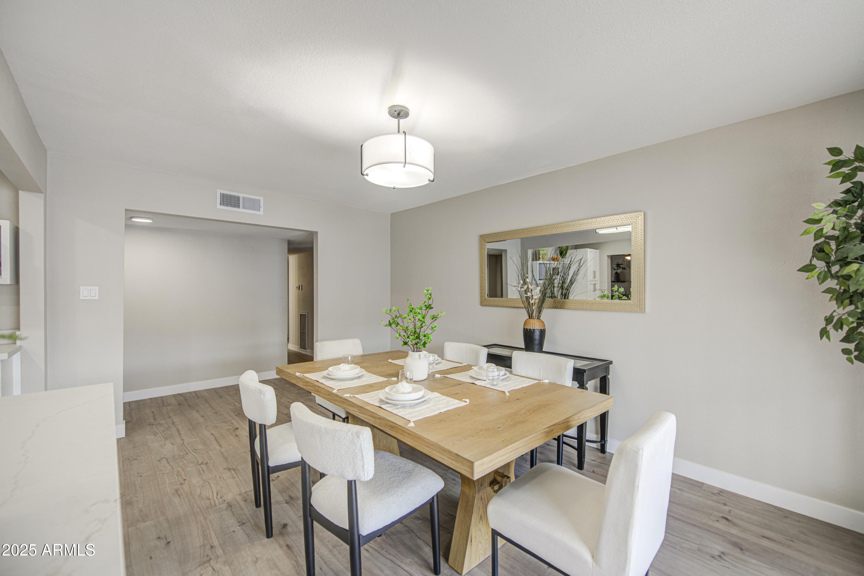 4750 North 39th Drive Phoenix, AZ 85019 - Photo 15 of 39 a view of a dining room with furniture and wooden floor