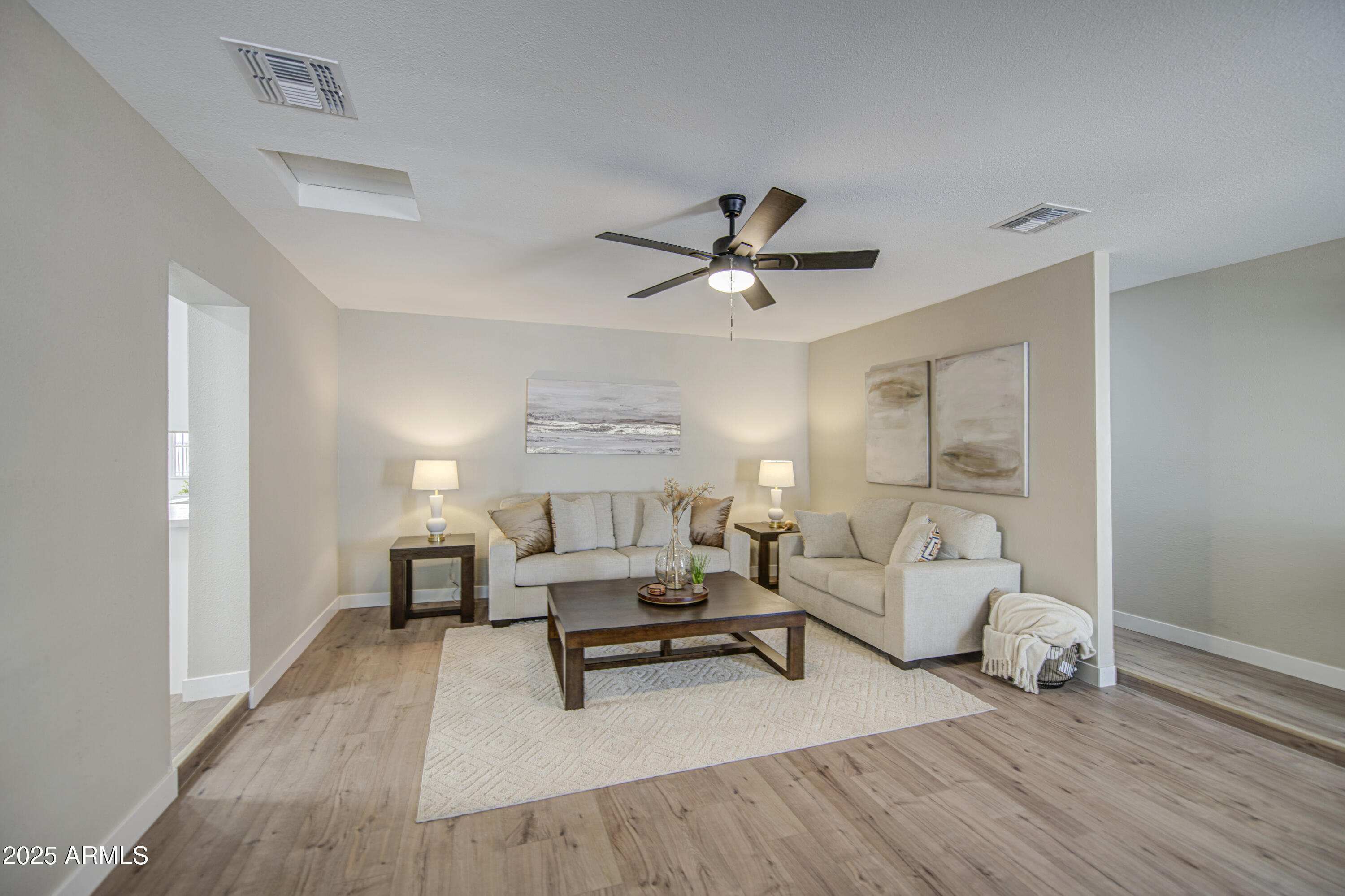 4750 North 39th Drive Phoenix, AZ 85019 - Photo 18 of 39 a living room with furniture and a wooden floor