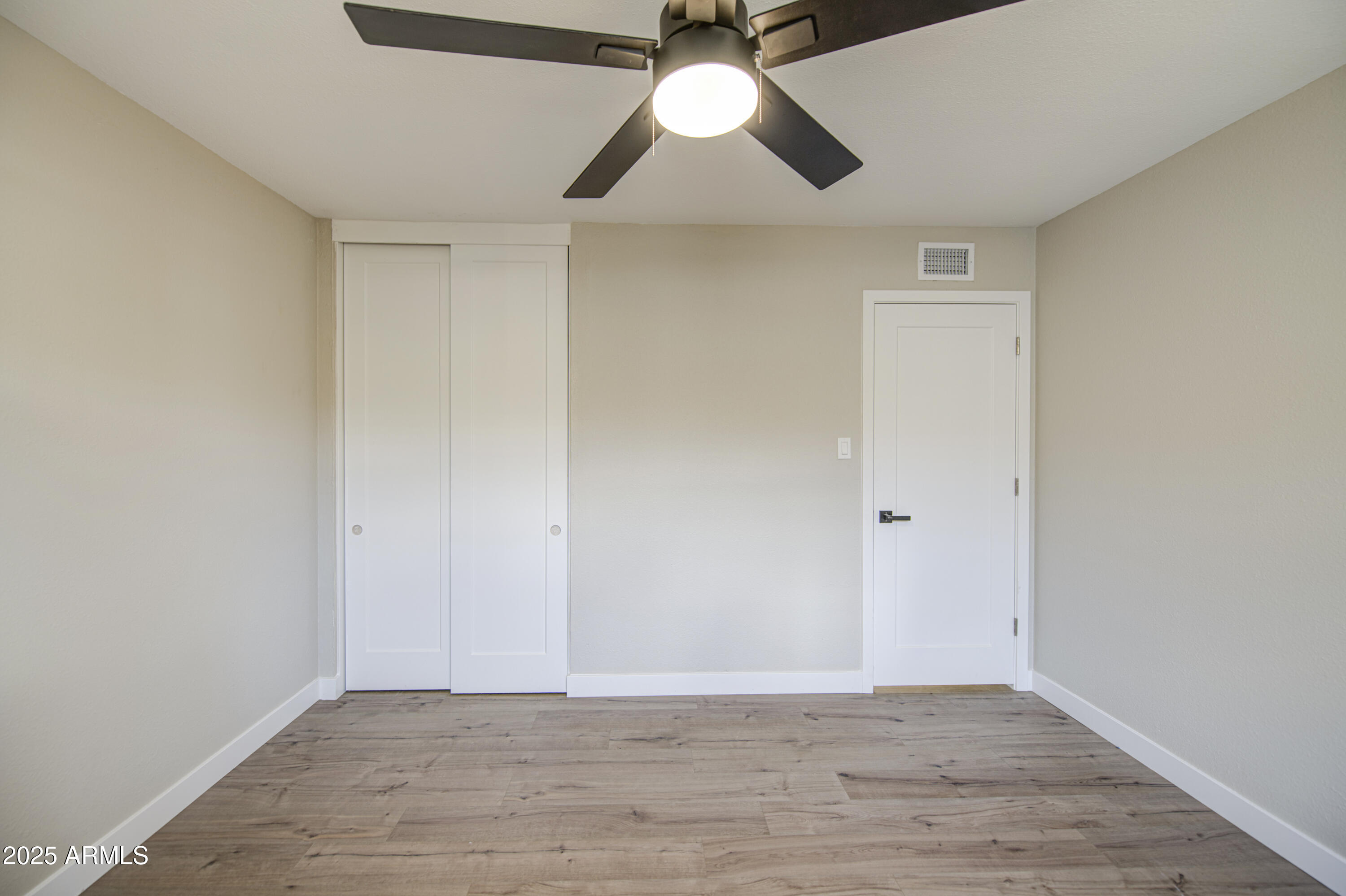 4750 North 39th Drive Phoenix, AZ 85019 - Photo 29 of 39 a view of an empty room with wooden floor