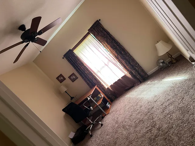 a view of an empty room and wooden floor