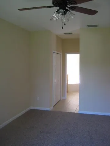 a view of a chandelier fan and refrigerator