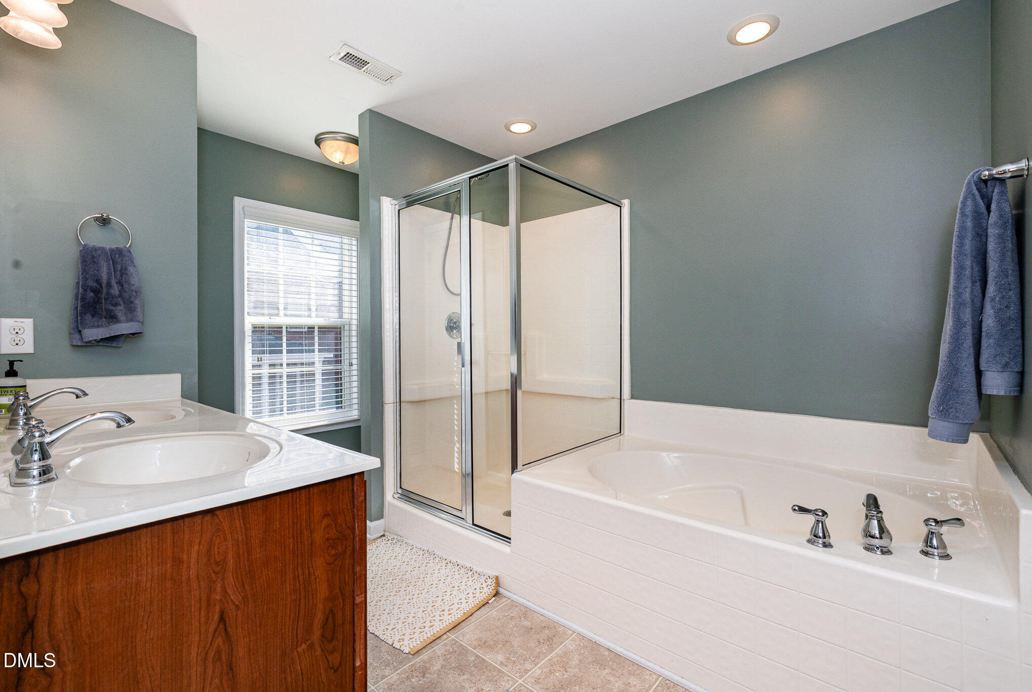 513 Dragby Lane Raleigh, NC 27603 - Photo 17 of 30 a bathroom with a tub sink and mirror