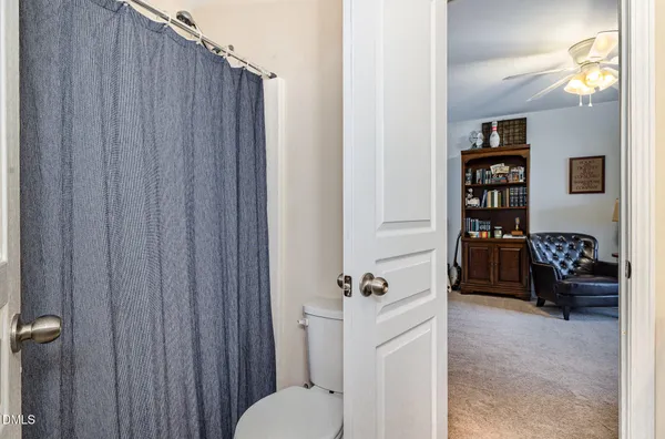 a bathroom with a toilet and a shower