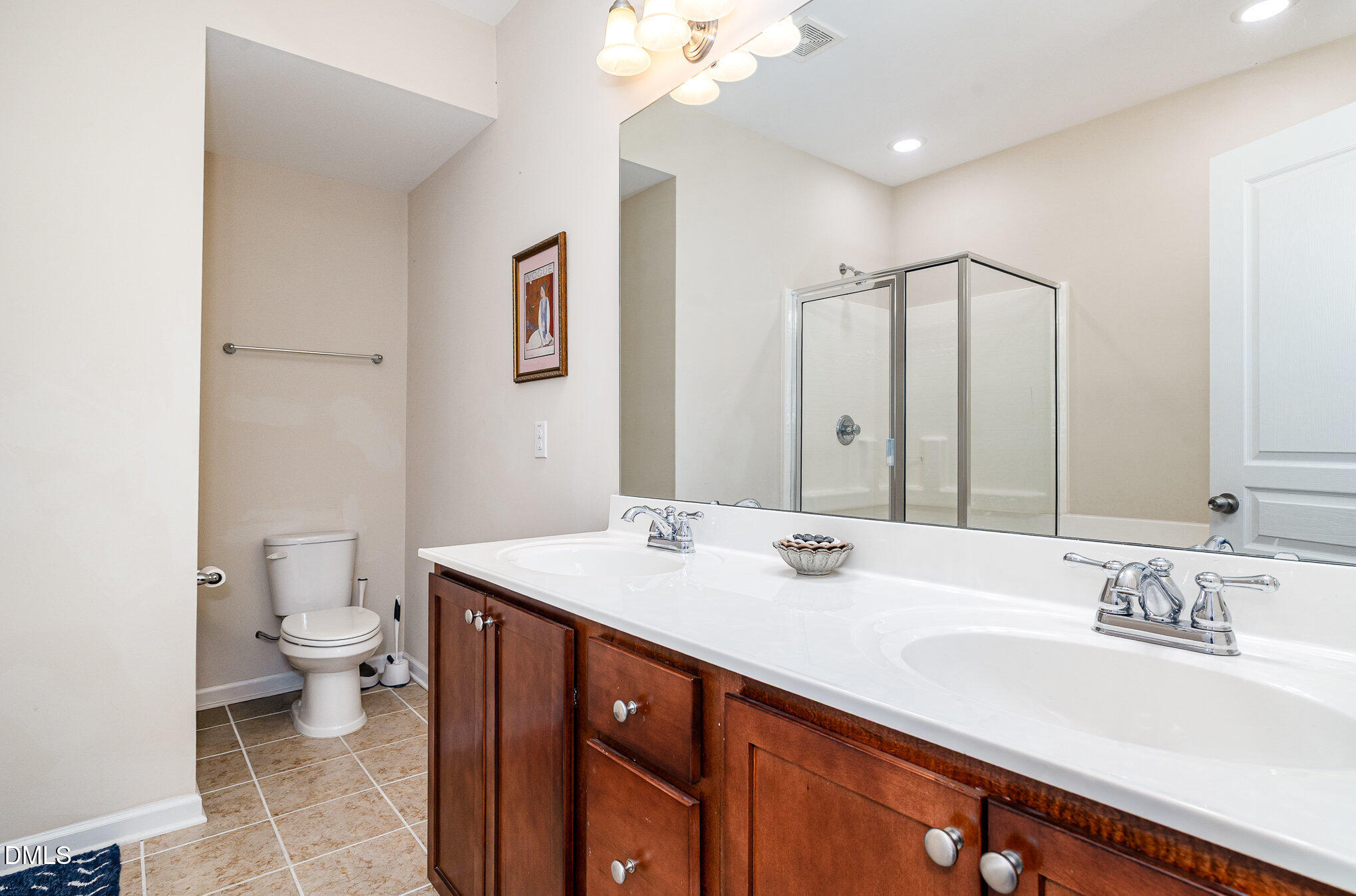 513 Dragby Lane Raleigh, NC 27603 - Photo 7 of 30 a bathroom with a sink a toilet and a large mirror