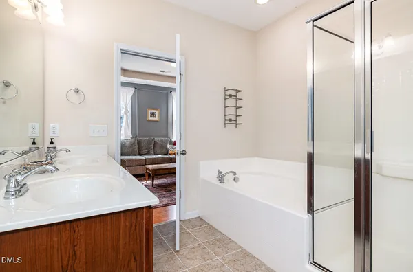 a bathroom with a sink a toilet and a large mirror