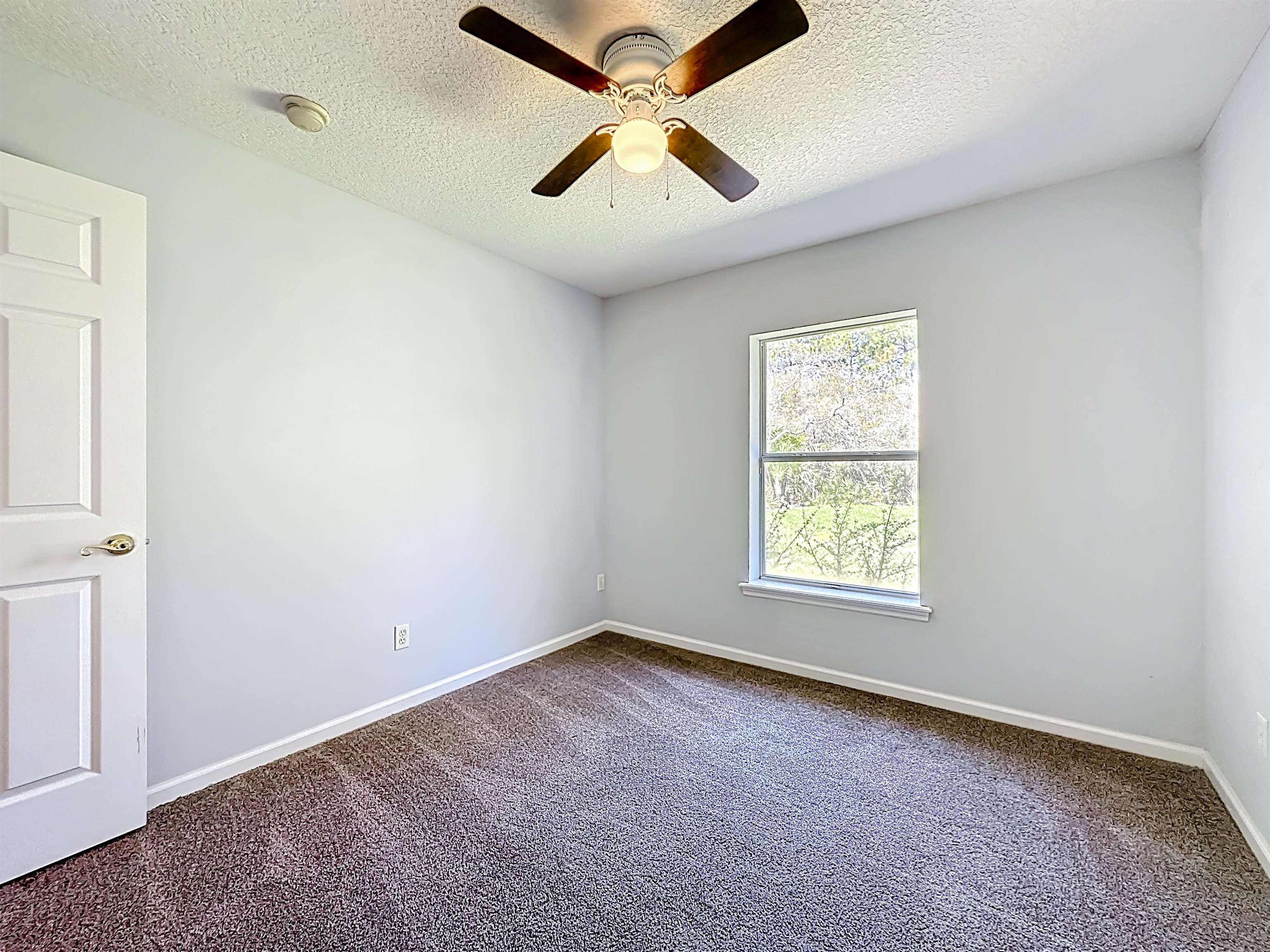 200 Merida Road St. Augustine, FL 32086 - Photo 15 of 66 an empty room with a window and a fan