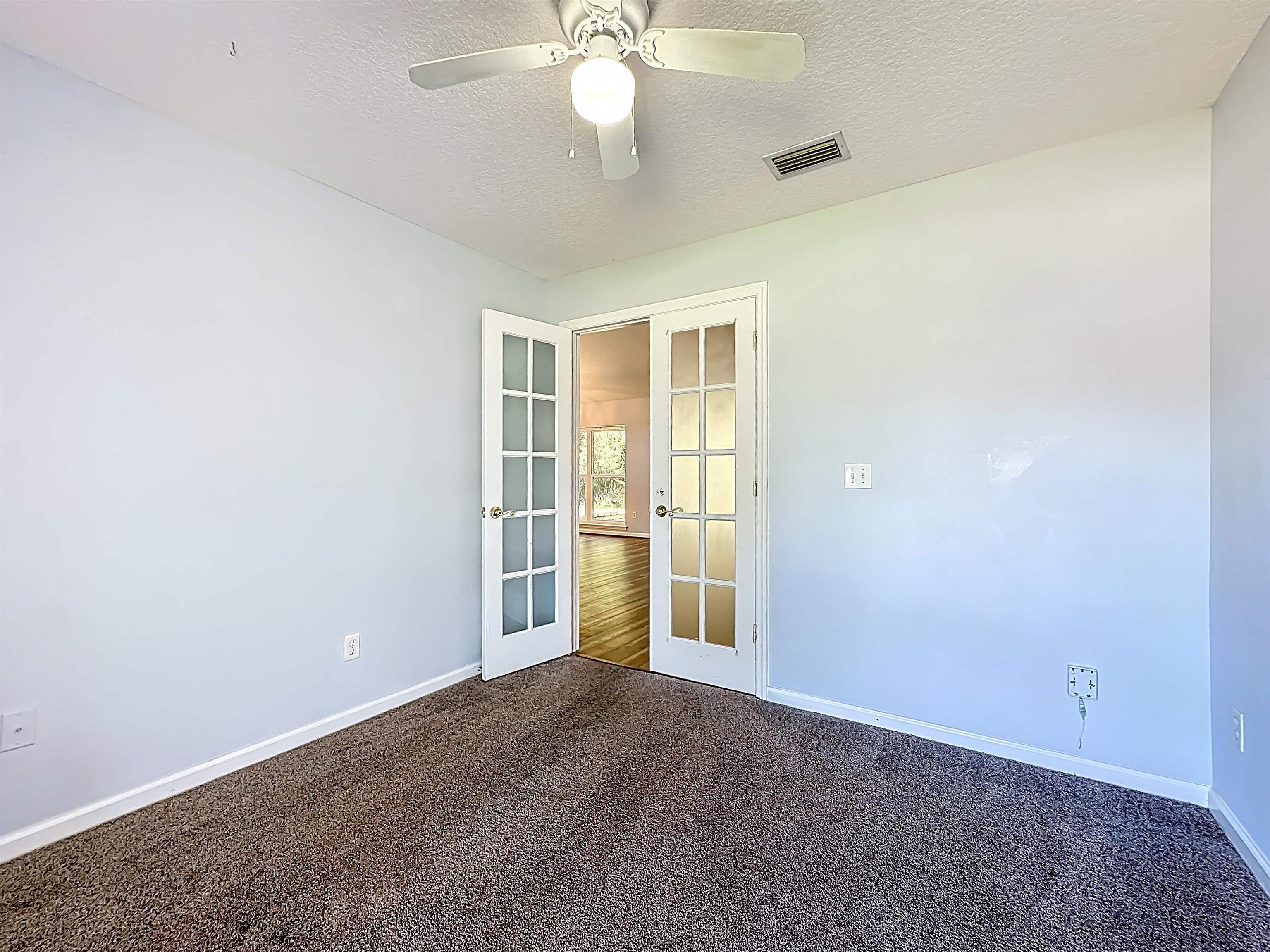 200 Merida Road St. Augustine, FL 32086 - Photo 17 of 66 an empty room with chandelier fan
