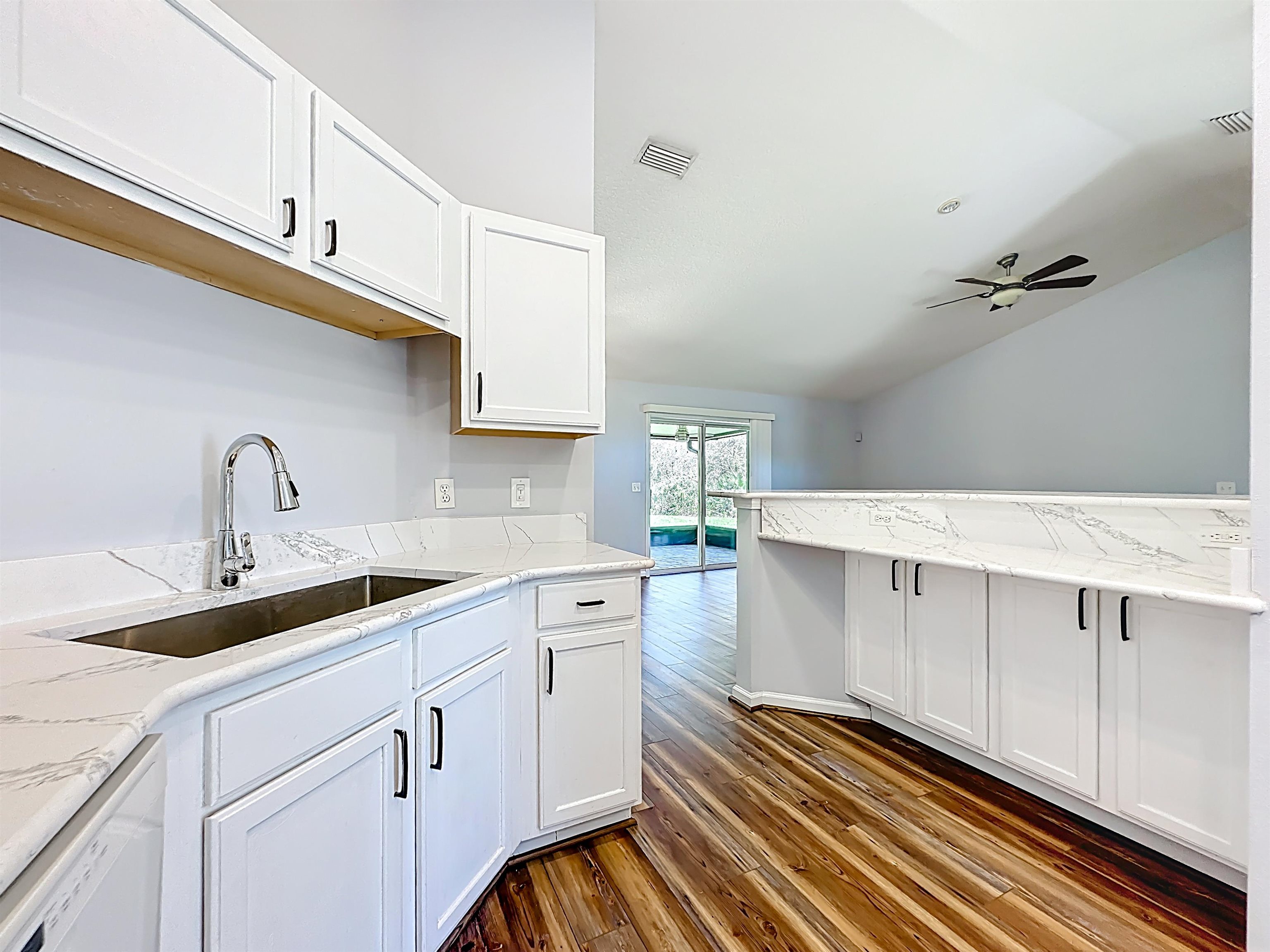 200 Merida Road St. Augustine, FL 32086 - Photo 23 of 66 a kitchen with a sink and cabinets