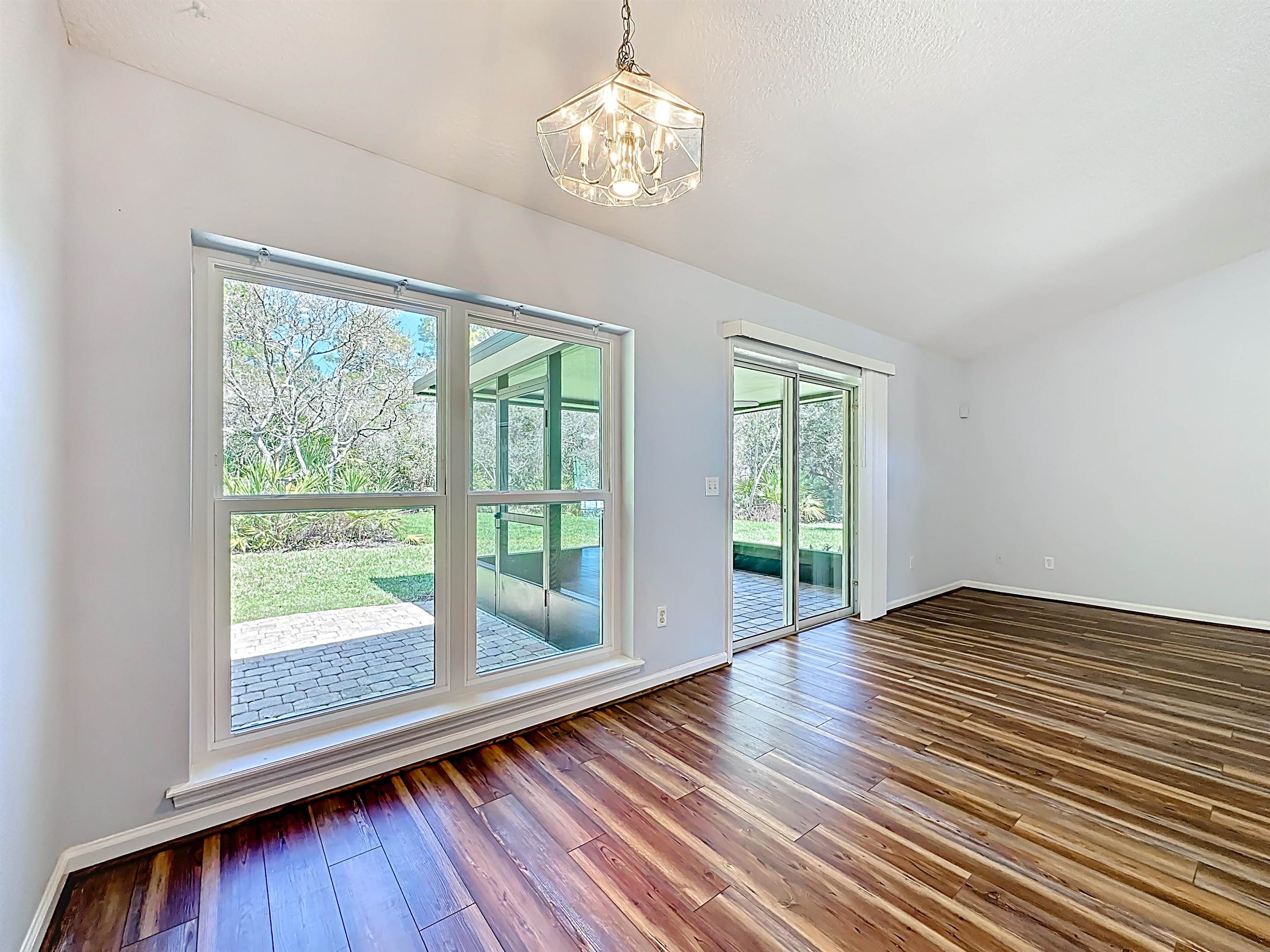 200 Merida Road St. Augustine, FL 32086 - Photo 26 of 66 a view of an empty room with wooden floor and a window