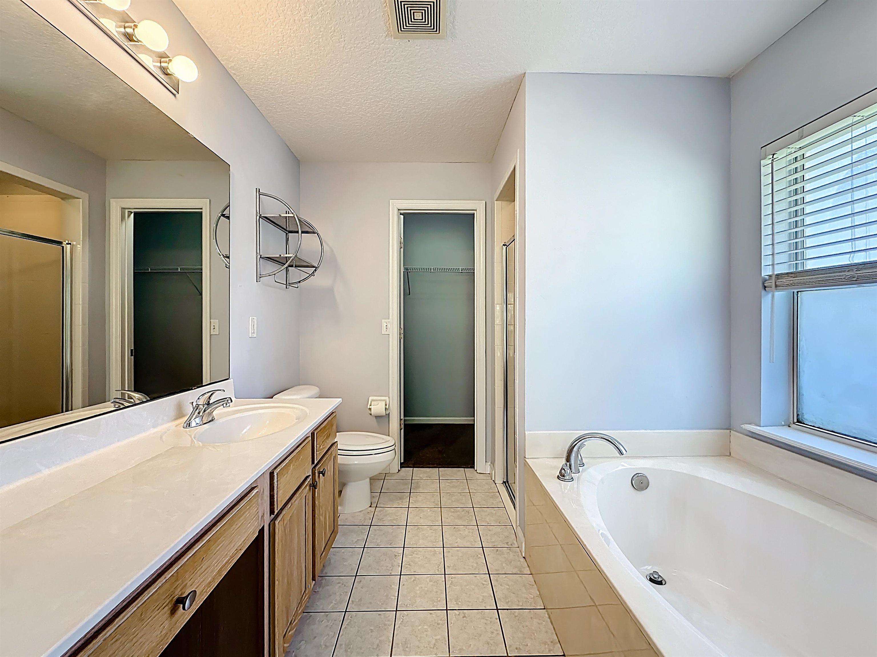 200 Merida Road St. Augustine, FL 32086 - Photo 32 of 66 a bathroom with a tub sink and a mirror