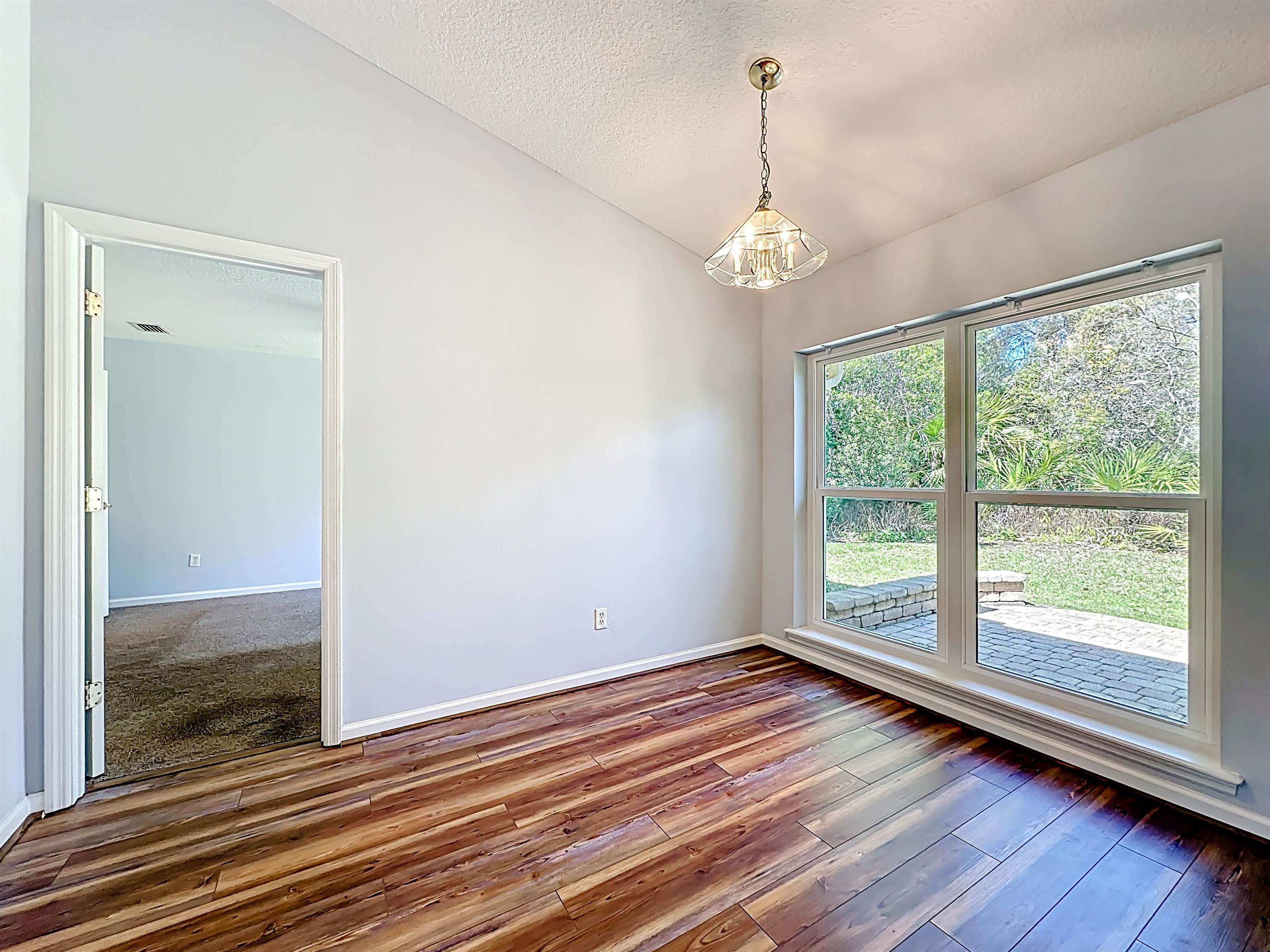 200 Merida Road St. Augustine, FL 32086 - Photo 8 of 66 wooden floor in an empty room with a window