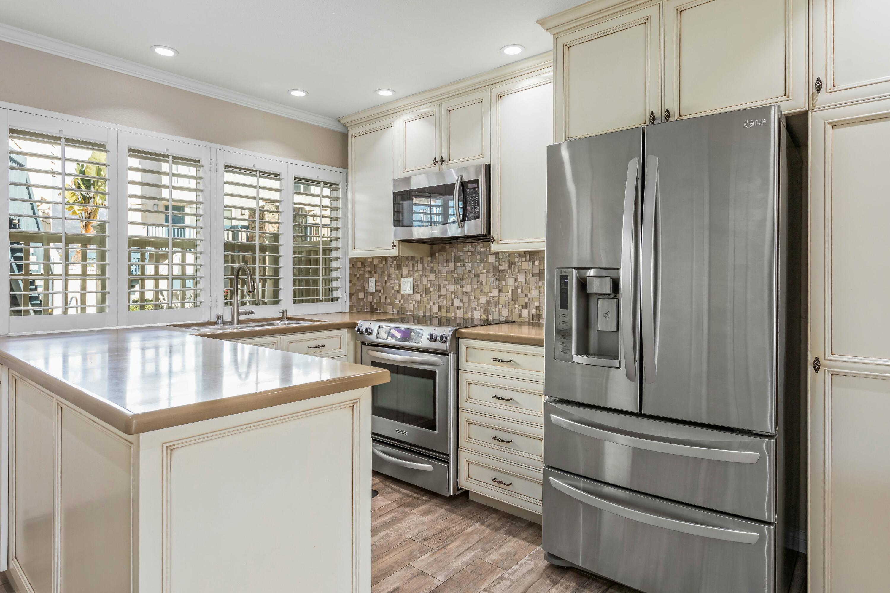 4700 Sandyland Road, Unit 12 Carpinteria, CA 93013 - Photo 6 of 27 a kitchen with stainless steel appliances granite countertop a refrigerator and a stove top oven