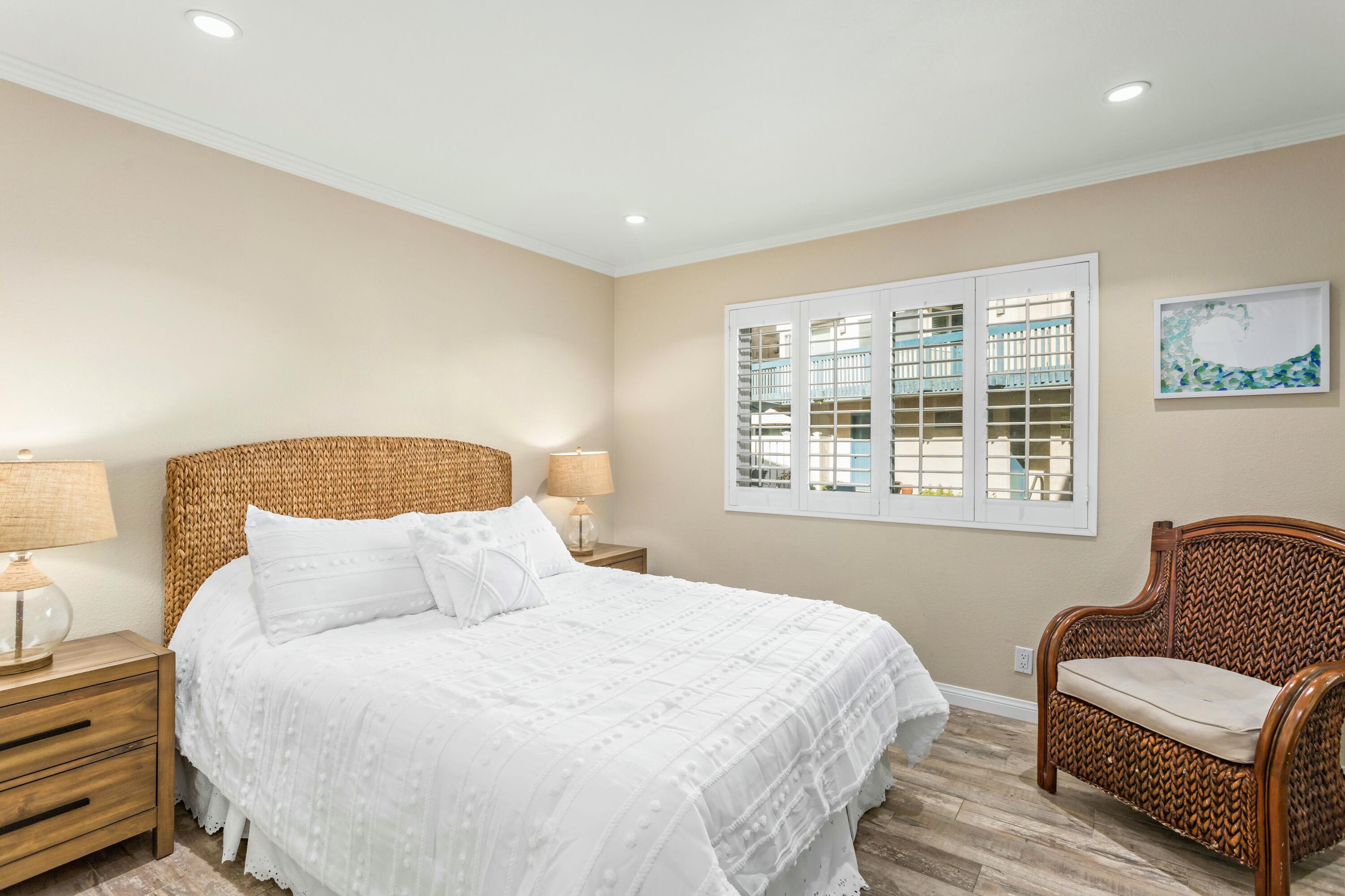 4700 Sandyland Road, Unit 12 Carpinteria, CA 93013 - Photo 8 of 27 a bedroom with a bed and wooden floor