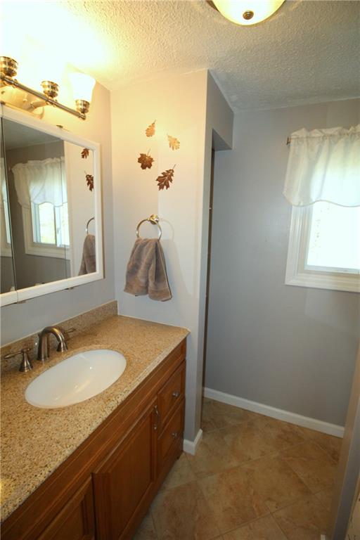 310 Fort Couch Road Pittsburgh, PA 15241 - Photo 12 of 25 Master bath has a granite countertop with a ceramic floor and shower.