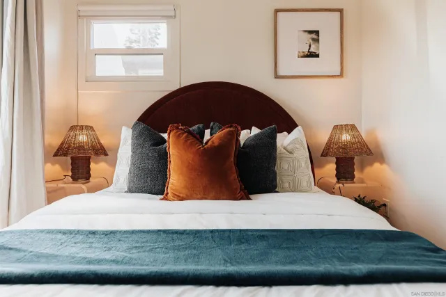 a bed sitting in a bedroom next to a window