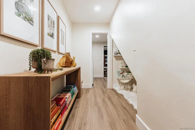 a living room with furniture and a painting on the wall