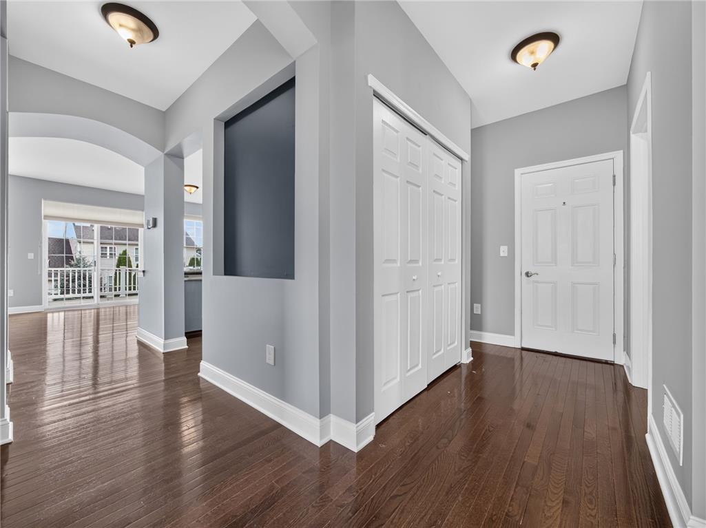 2765 Farmstead Road Easton, PA 18040 - Photo 8 of 50 Rich hardwood flooring guides you through this elegant entryway toward an arched opening and outdoor balcony views.