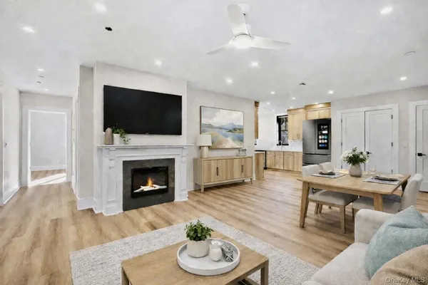 a living room with furniture a fireplace and a flat screen tv