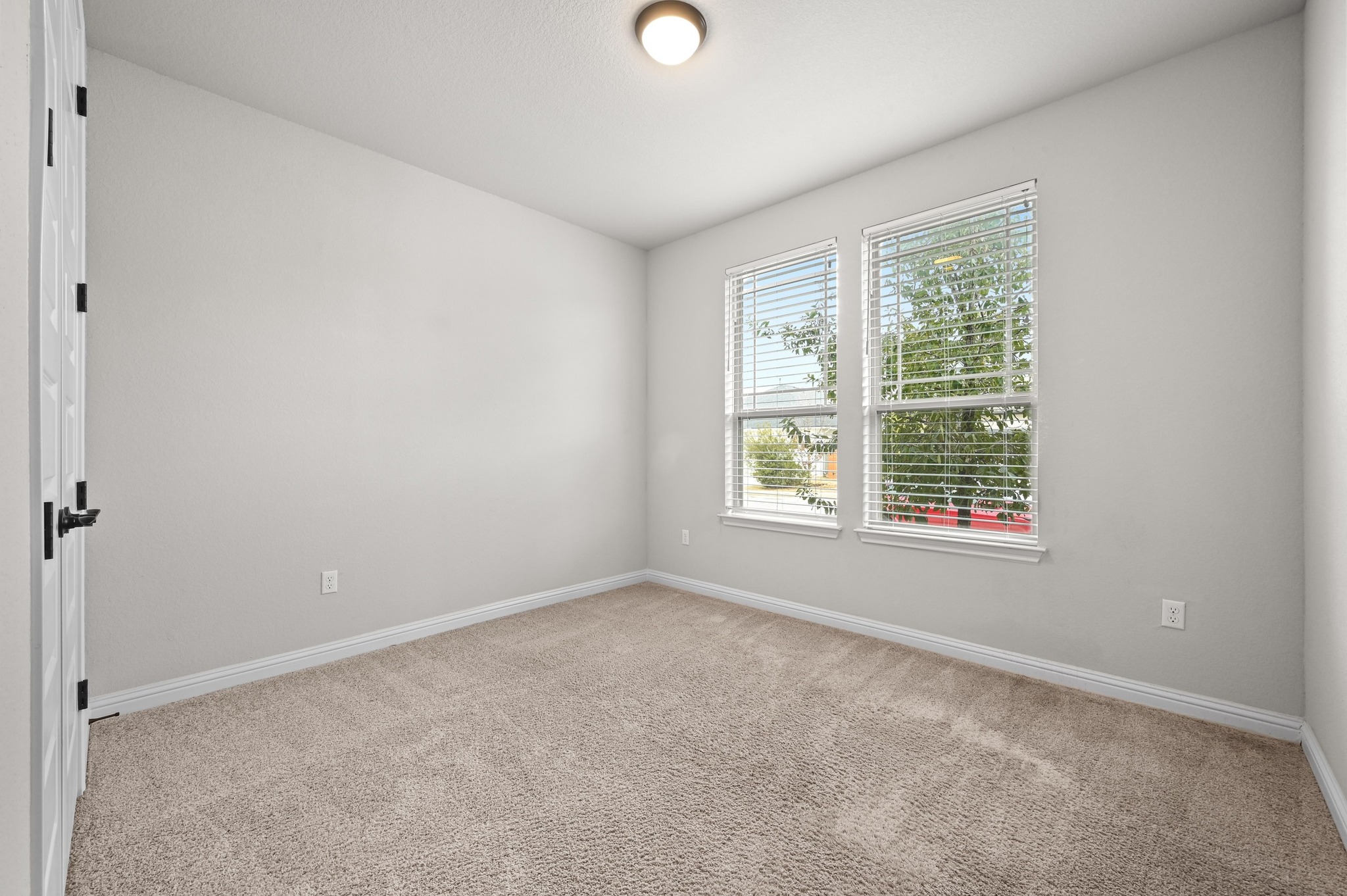 8003 Orizzonte Street Austin, TX 78744 - Photo 15 of 25 Spare room featuring carpet floors and baseboards