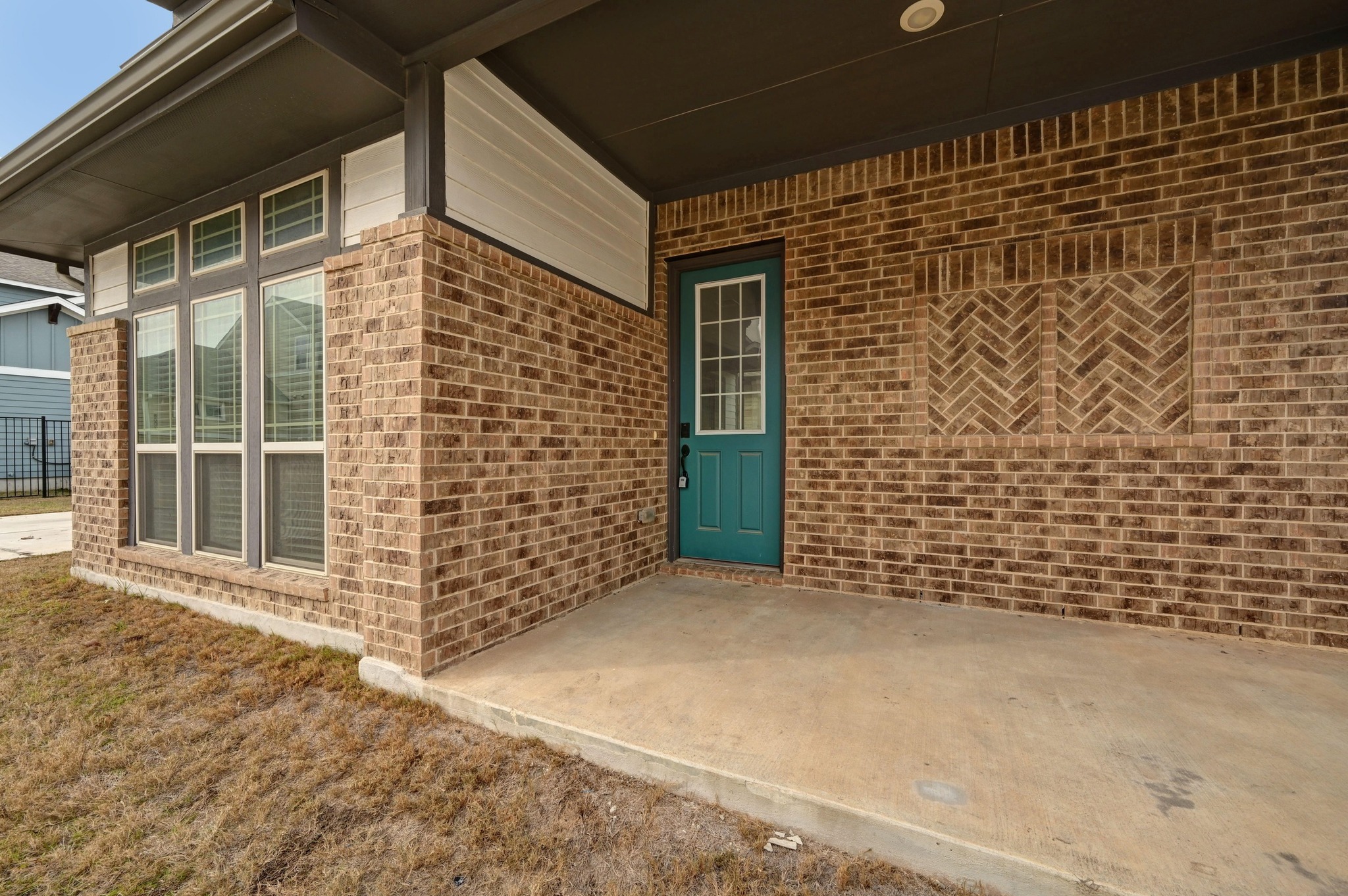 8003 Orizzonte Street Austin, TX 78744 - Photo 4 of 25 Entrance to property featuring brick siding