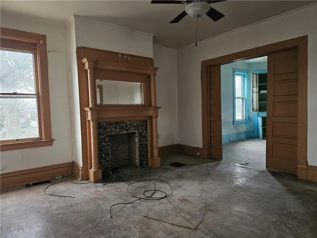 an empty room with windows and cabinet