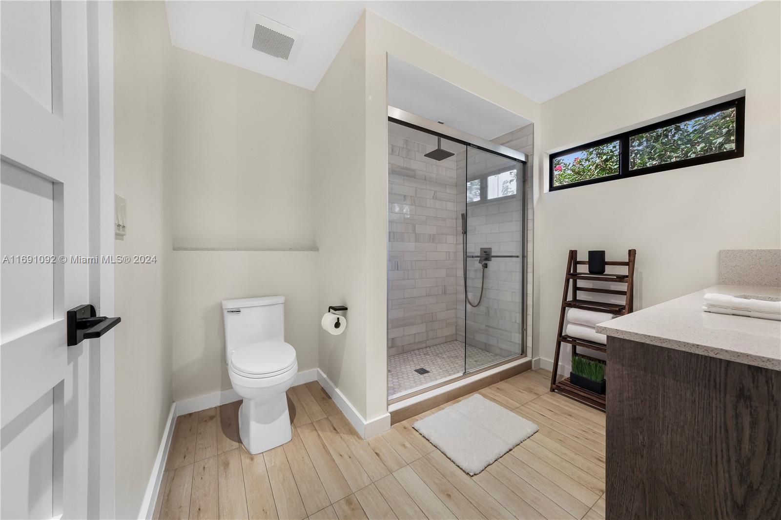 2429 Southwest 25th Terrace Miami, FL 33133 - Photo 12 of 35 a bathroom with a shower a toilet and a sink